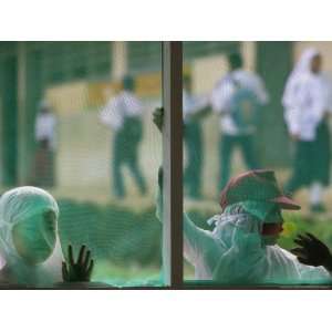  School Children Look Through Holes in the Window Screens 