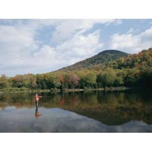  A Fisherman and His Reflection are Surrounded by the 