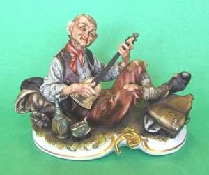 Capodimonte style figure Vagabond with guitar detailed  