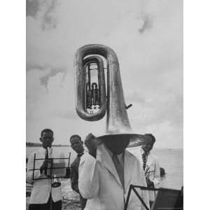  Tuba Player Keeping His Head Dry in a Rainstorm During 