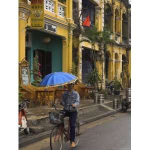  Man Riding a Bike and Holding Umbrella, Hoi An, Indochina 