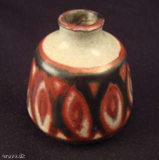 wonderful iridescent red and bluish glazes over sand colored base