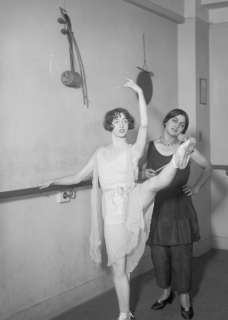 1900s photo of two ballerinas nest to Ballet barre  